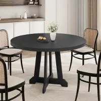 StarTech.com Mesa redonda moderna para comedor, fabricada en madera maciza, con un diámetro de 120 cm, ideal para 4 personas, con patas cónicas y ruedas, color negro